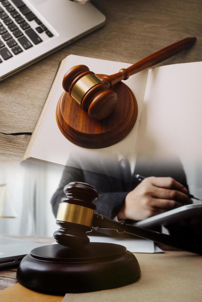 Male lawyer working with contract papers and wooden gavel on tabel in courtroom. justice and law ,attorney, court judge, concept. photo