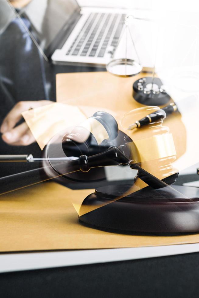 Business and lawyers discussing contract papers with brass scale on desk in office. Law, legal services, advice, justice and law concept picture with film grain effect photo