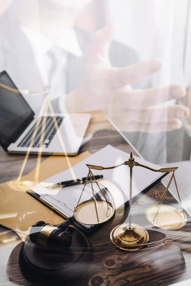Business and lawyers discussing contract papers with brass scale on desk in office. Law, legal services, advice, justice and law concept picture with film grain effect photo