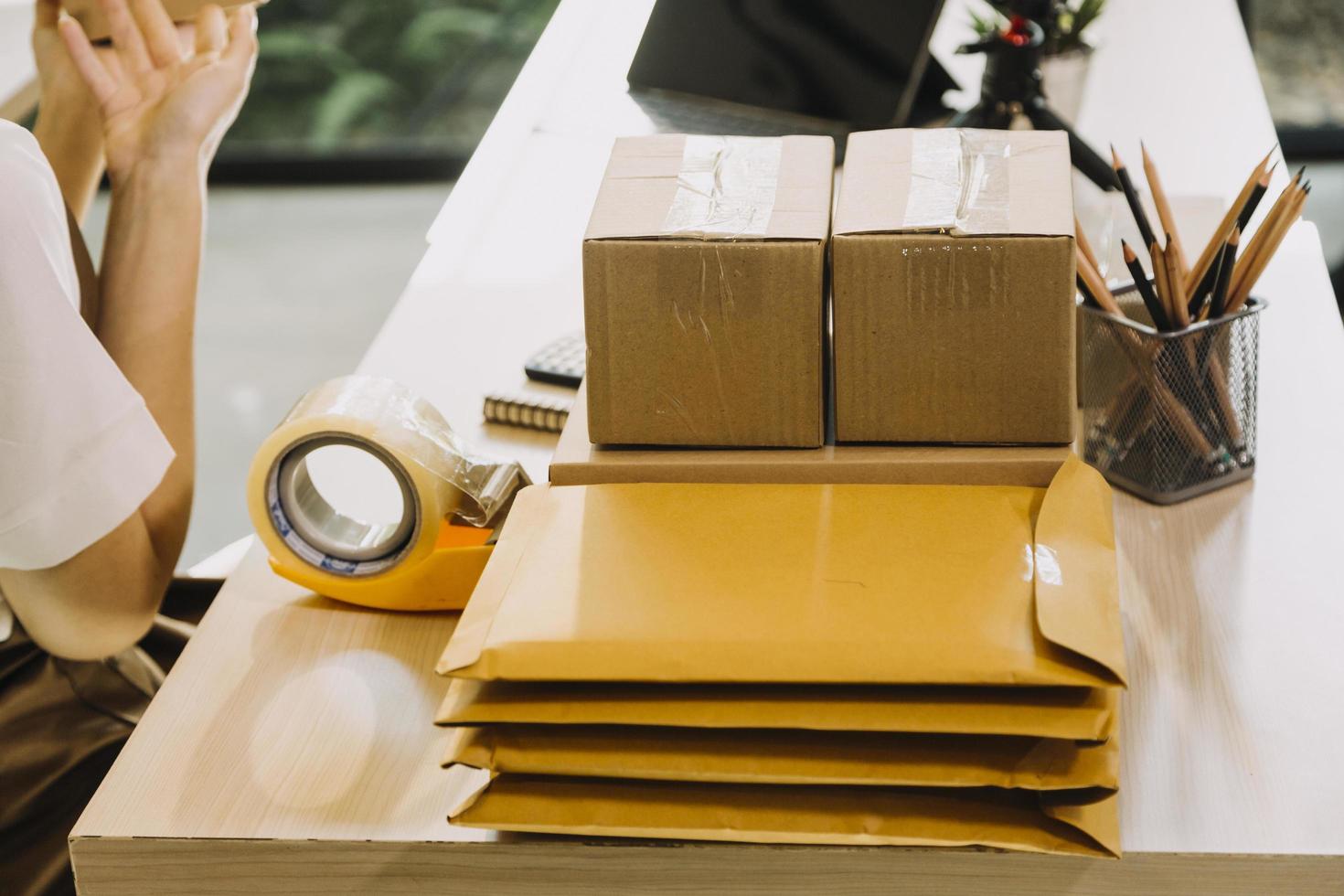 Portrait of Starting small businesses SME owners, two Asian woman check online orders Selling products working with boxs freelance work at home office, sme business online small medium enterprise photo