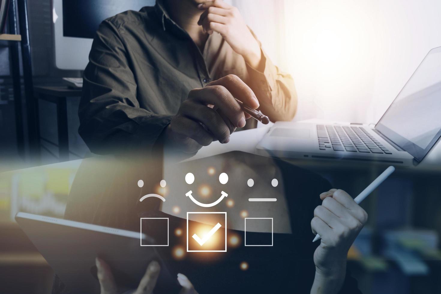 Customer service evaluation concept. Businessman pressing face smile emoticon show on virtual screen. Survey, poll or questionnaire for user experience or customer satisfaction research. photo
