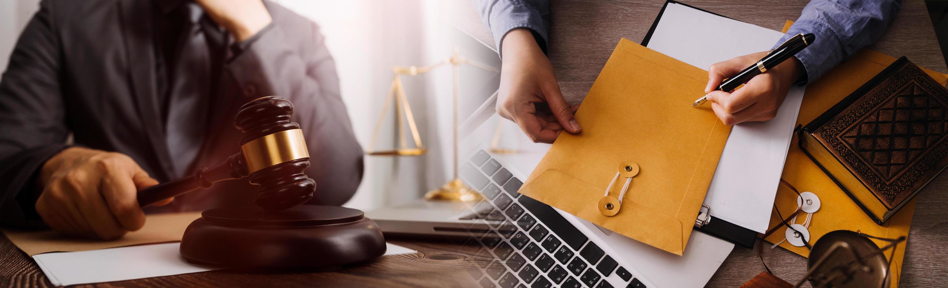 Justice and law concept. Gavel on sounding block in hand's Male judge at a courtroom, working with document law books, report the case on table in modern office. photo
