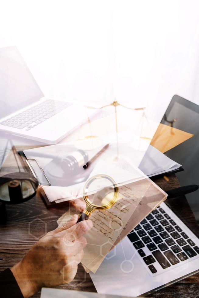 Business and lawyers discussing contract papers with brass scale on desk in office. Law, legal services, advice, justice and law concept picture with film grain effect photo