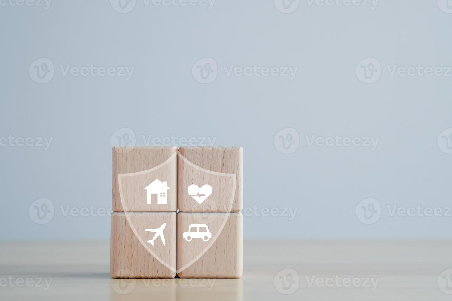 Insurance concept. Protection against a possible eventuality. House, Car, travel and Health icon on wooden block for assurance life concept. photo