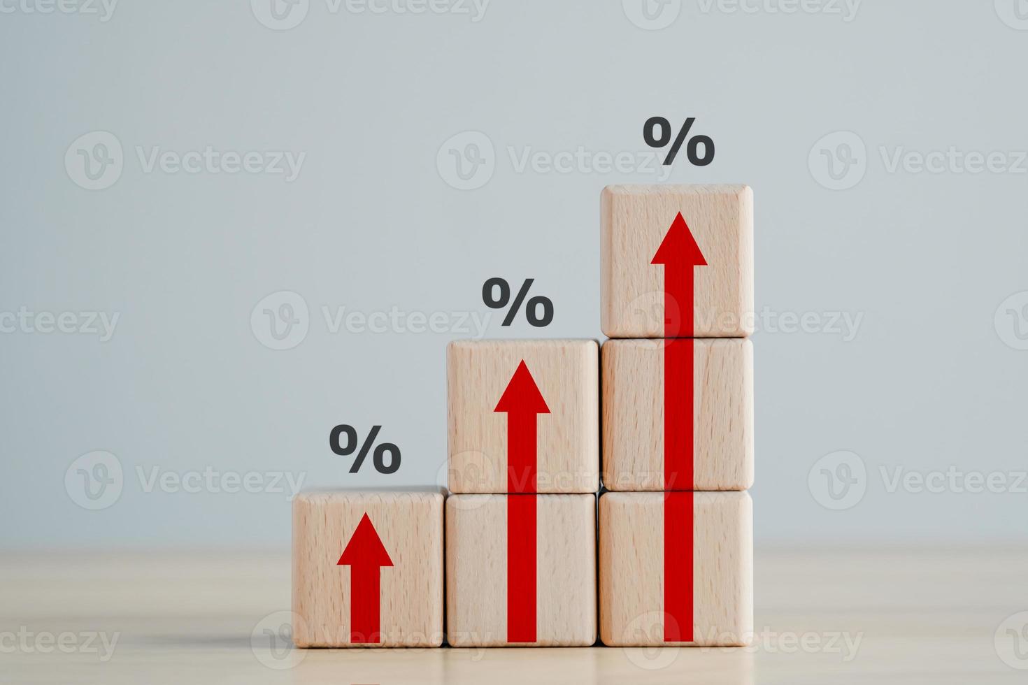 Interest rate finance and mortgage rates concept.  Wooden blocks with red arrow up and percentage sign, financial growth, interest rate increase, inflation, sale price and tax rise concept. photo