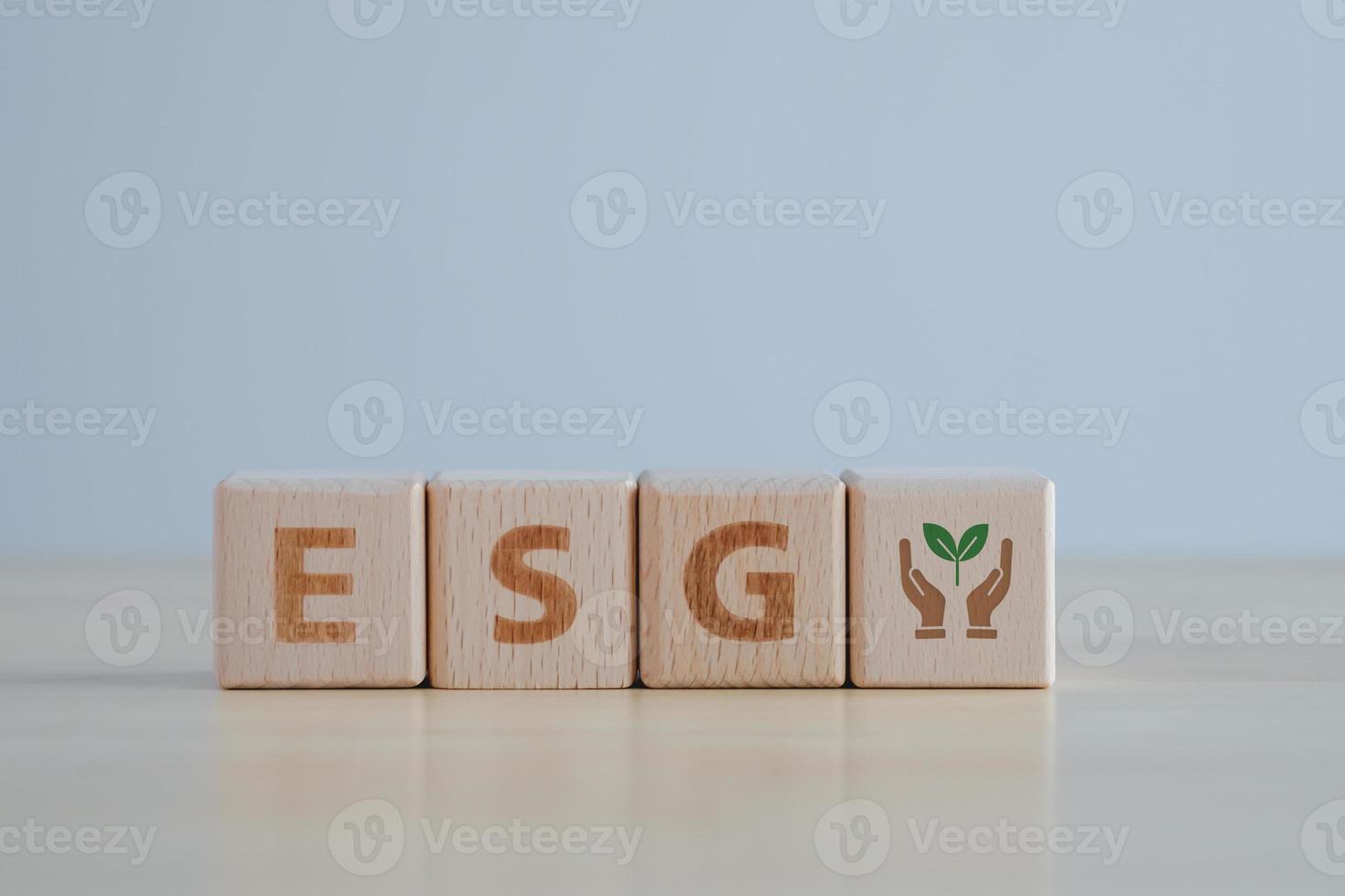 ESG concept of environmental. Sustainable business or green business background with words ESG on a wood block concept for environmental, social, and governance in sustainability and ethical business. photo