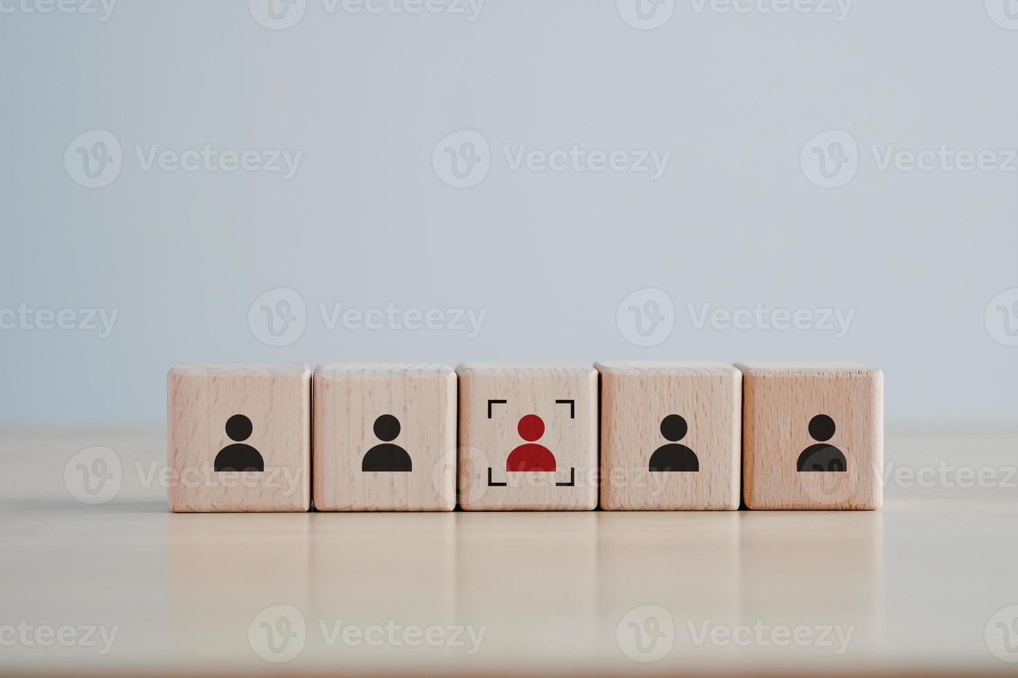 Business hiring and recruitment selection. Career opportunity. Human Resource Management. Focus red human icon on wooden block. Choice of employee leader from the crowd. photo