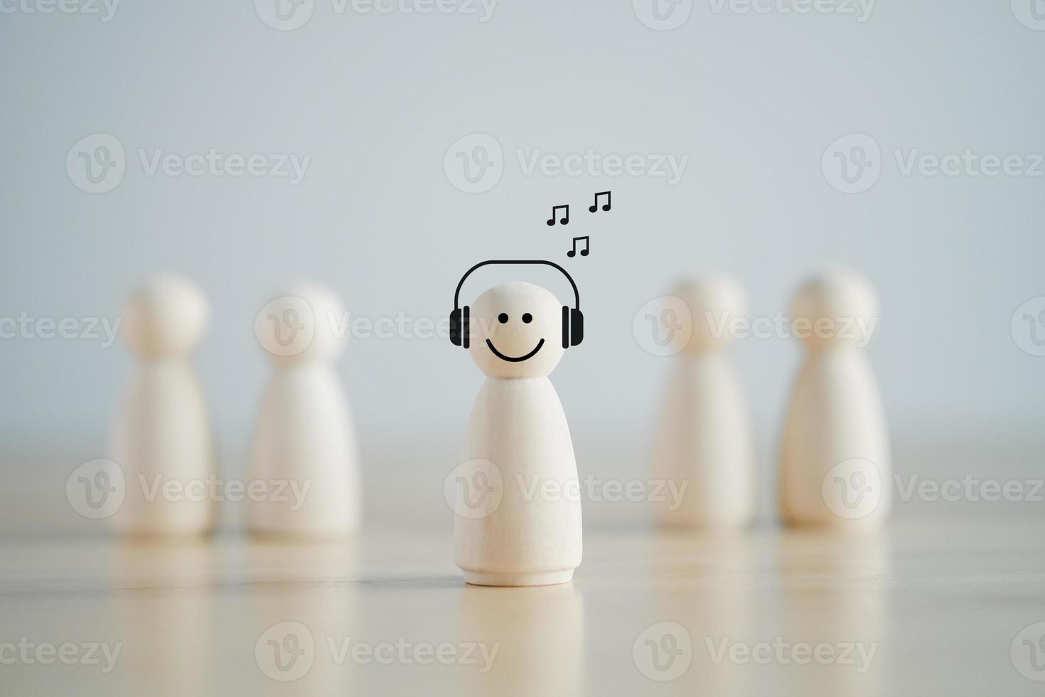 Introvert Person. Individuality. Unique. Person who Happy and Enjoy by Solitude, Spent Time alone. Wooden figure happy with listen music alone among many crowd. Psychology Personality Concept. photo