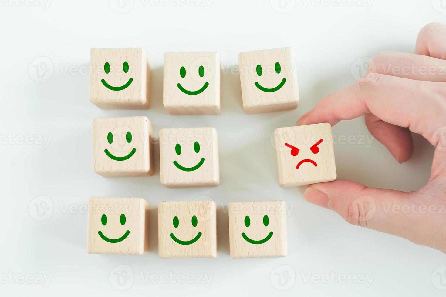 Hand pick angry face out from smile face for remove or reject negative thinking and negative emotion. mindset, attitude, satisfaction and Emotional Control. photo