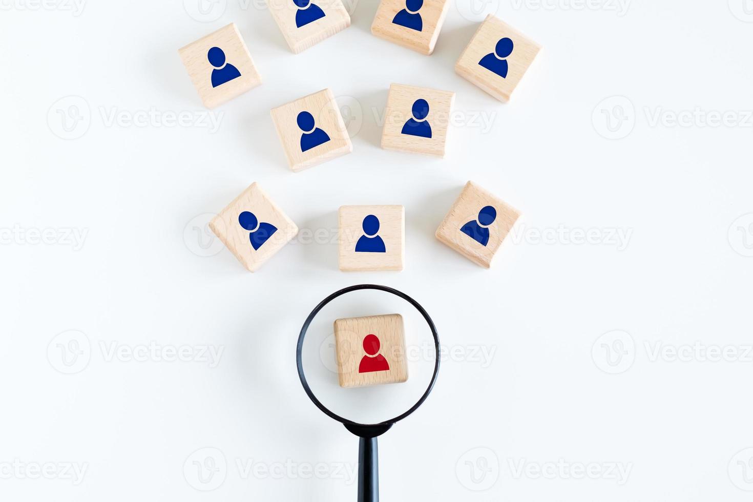 Human resources management and recruitment business hiring concept, professional staff research, head hunter job, magnifying glass looking for red employees icon on wood cube. photo