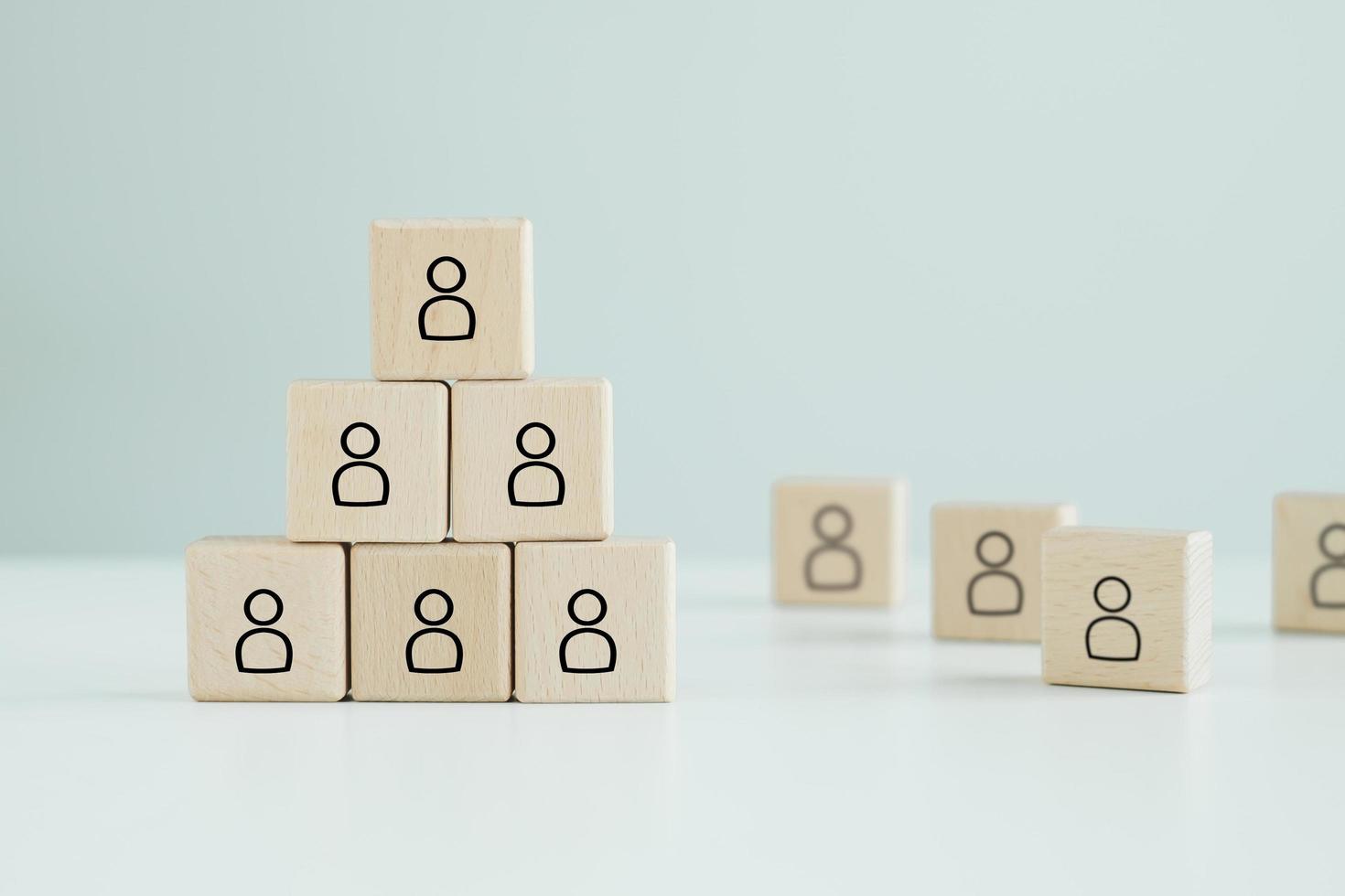 Wooden blocks with people icon. Successful team leader, Teamwork, Building a strong team, corporate hierarchy, professional staff,  Human resources management and recruitment business hiring concept. photo