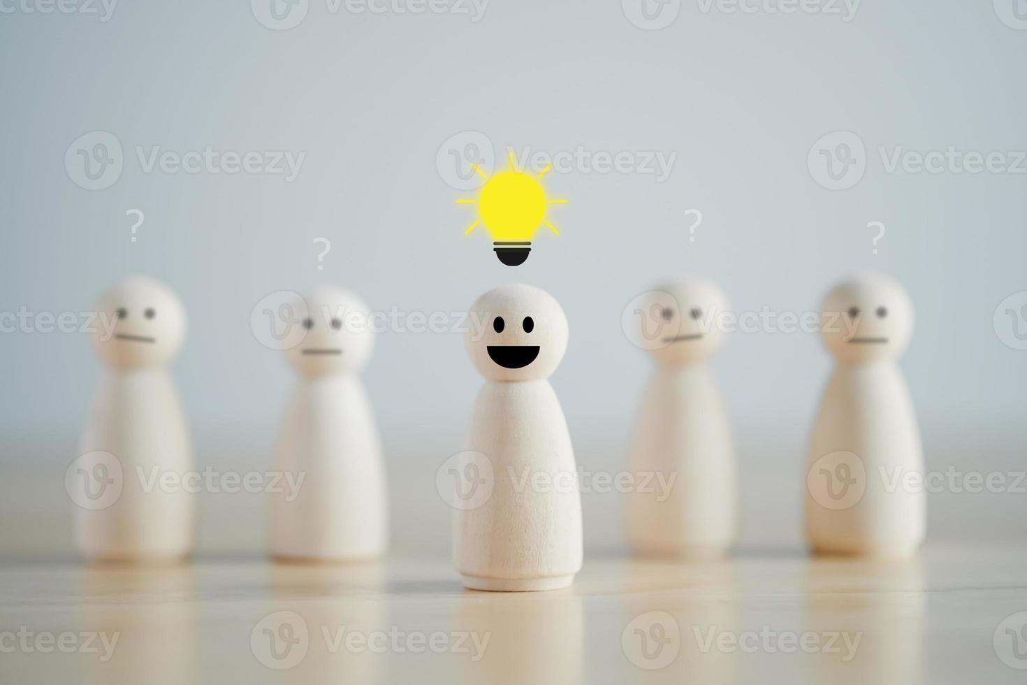 Leader with idea and innovation and creativity concept. Creative process concept and problem solution. happy face wooden human and glowing light bulb. Standing out from the crowd. photo