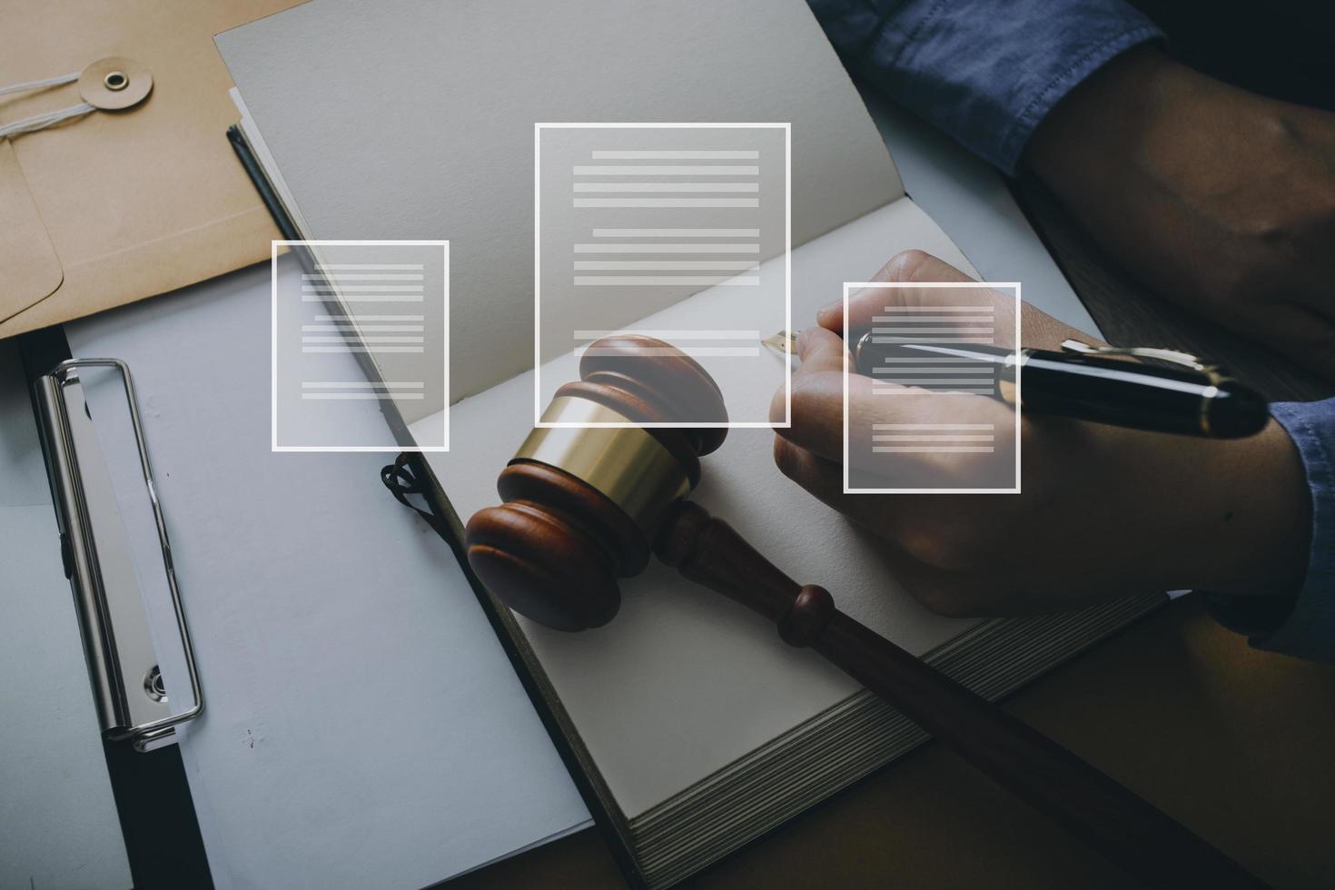 Male lawyer working with contract papers and wooden gavel on tabel in courtroom. justice and law ,attorney, court judge, concept. photo