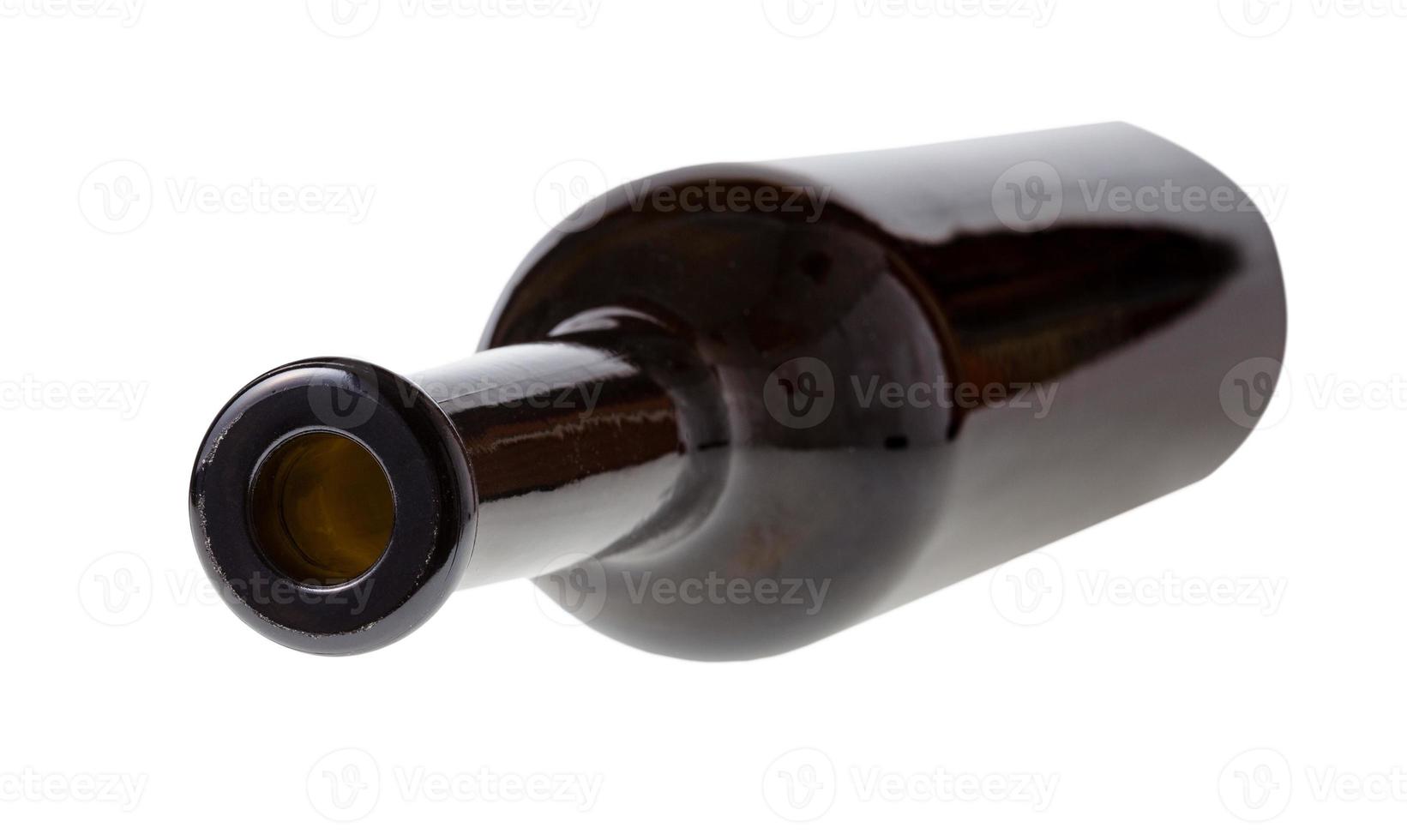 overturned empty dark brown wine bottle isolated photo