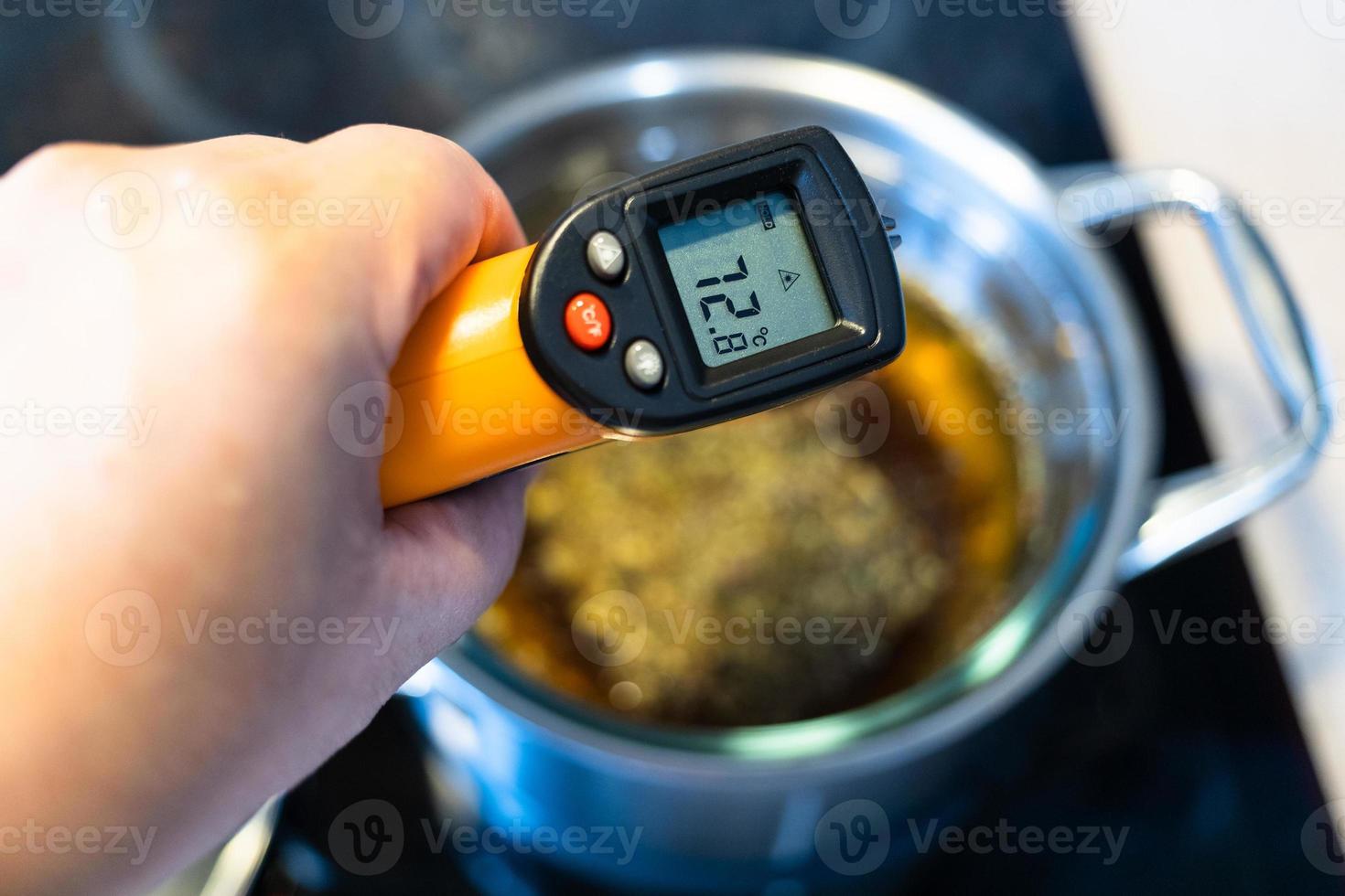 measuring temperature of cooking by thermometer photo