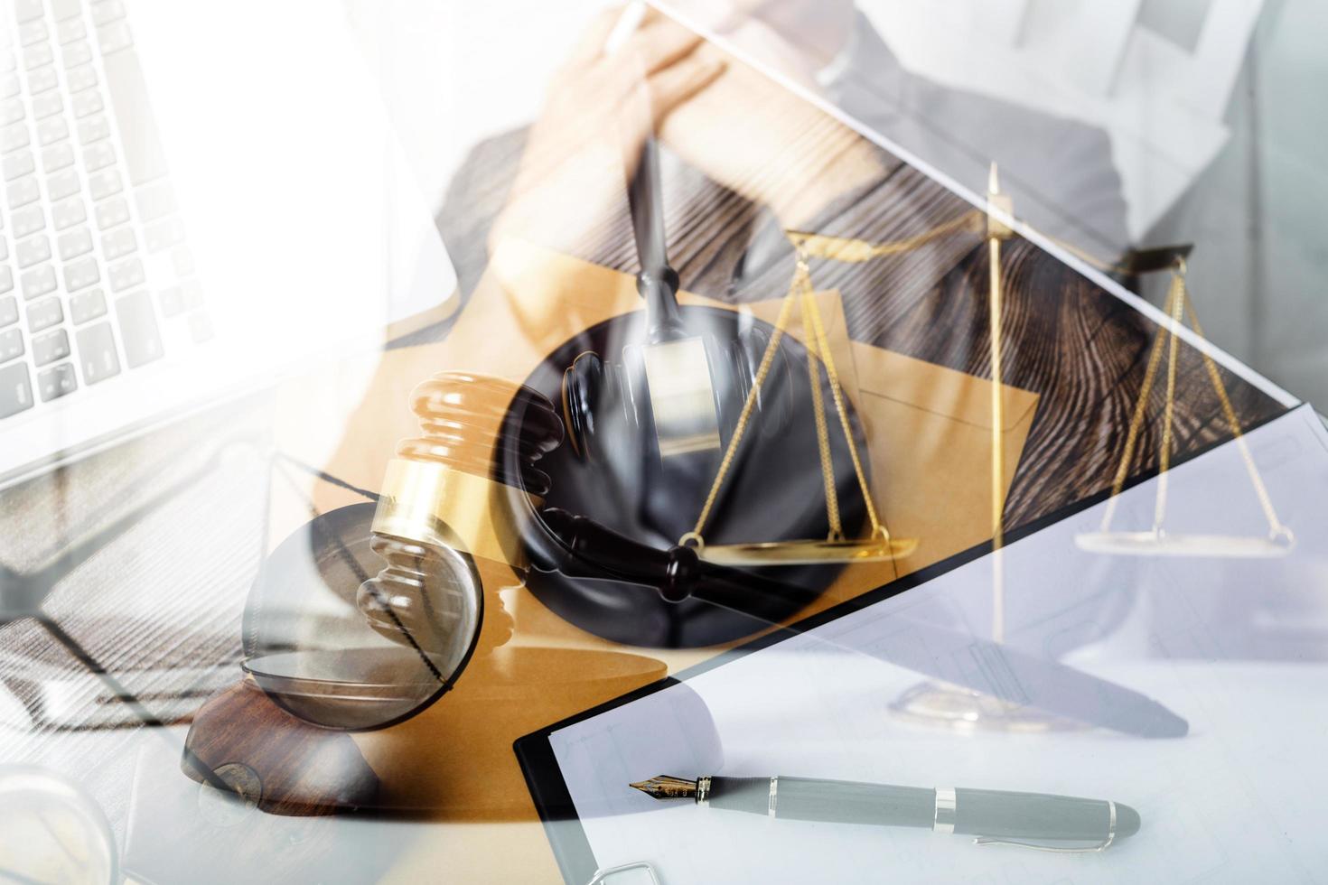 Business and lawyers discussing contract papers with brass scale on desk in office. Law, legal services, advice, justice and law concept picture with film grain effect photo