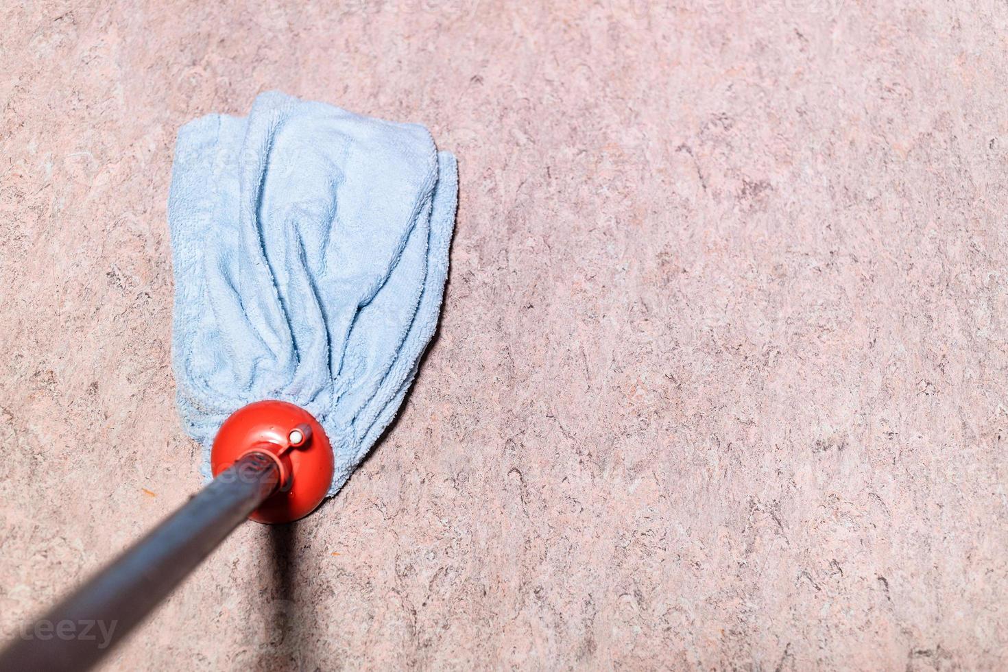 mop is wiping linoleum floor at home photo