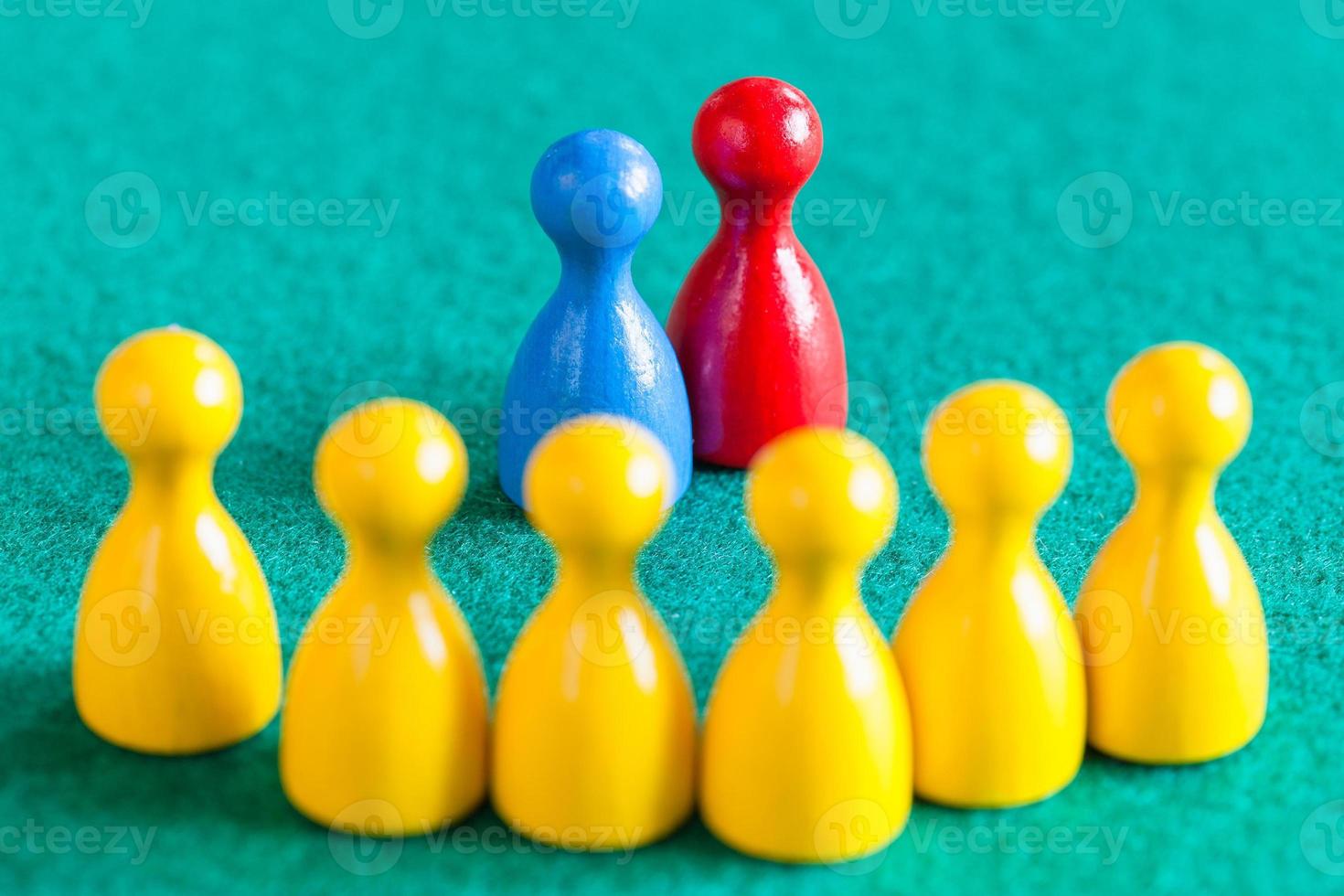 blue and red pawns in front of yellow pawns photo