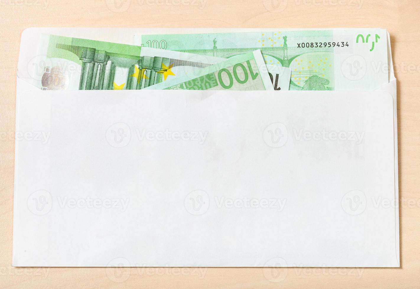 many one hundred euro notes in envelope on table photo
