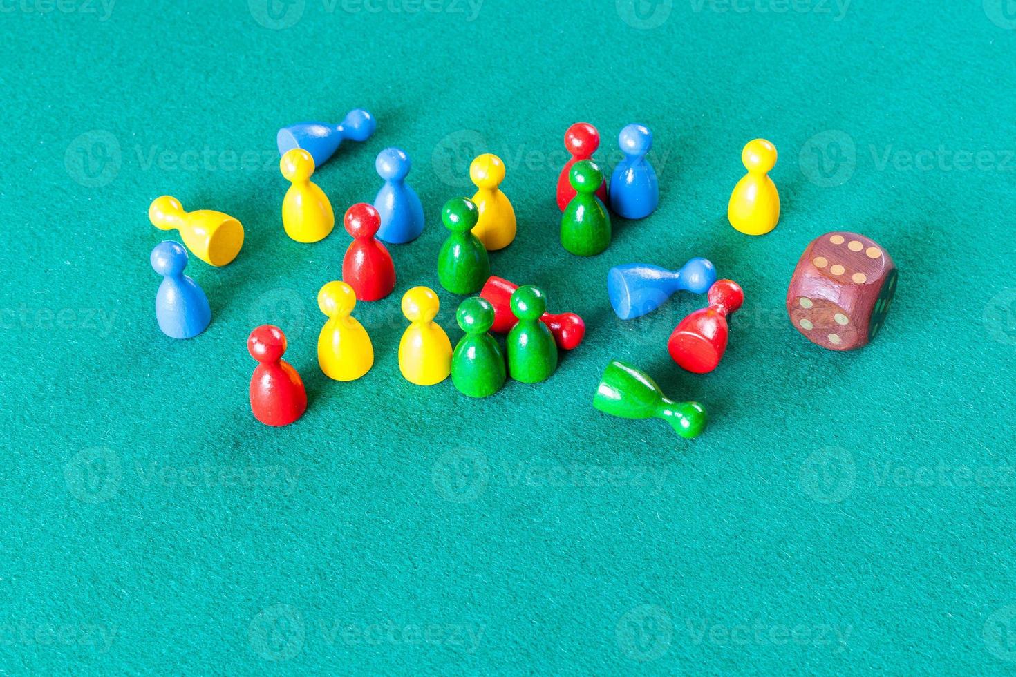 wooden dice and multicolored board game pawns photo