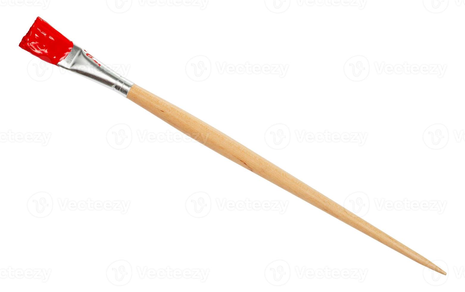 flat paint brush with red tip and wooden handle photo