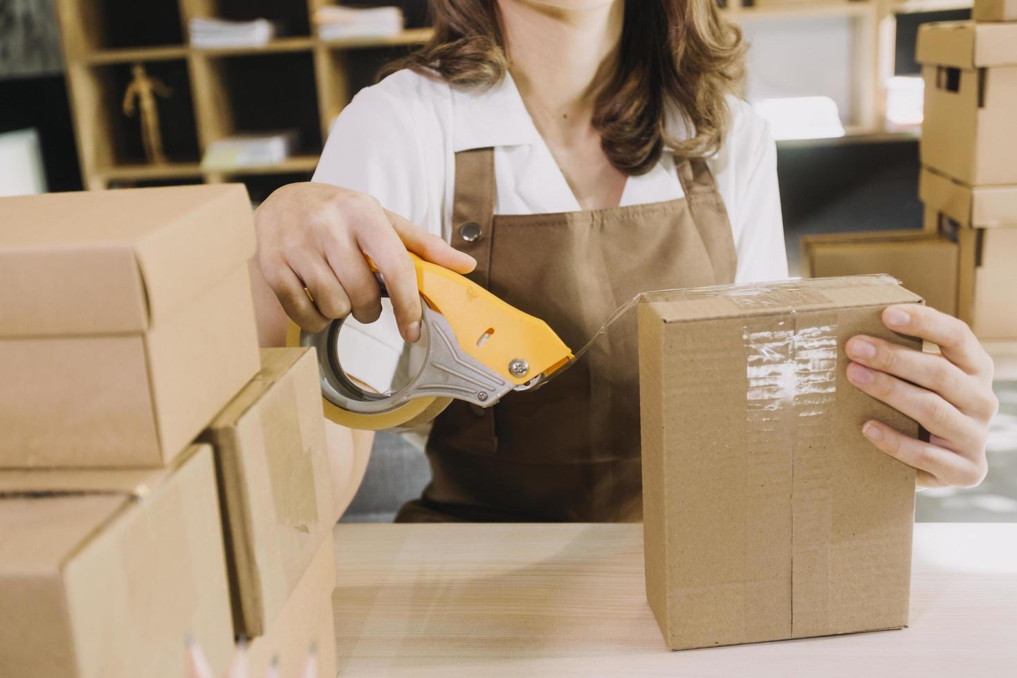 Portrait of Starting small businesses SME owners, two Asian woman check online orders Selling products working with boxs freelance work at home office, sme business online small medium enterprise photo