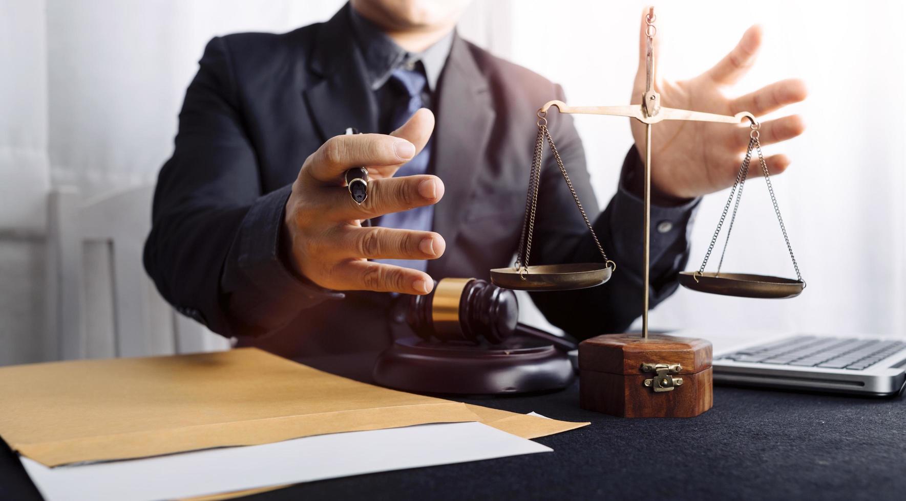 Business and lawyers discussing contract papers with brass scale on desk in office. Law, legal services, advice, justice and law concept picture with film grain effect photo