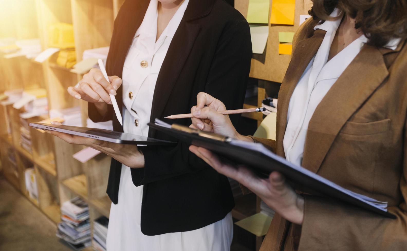 Woman accountant use calculator and computer with holding pen on photo