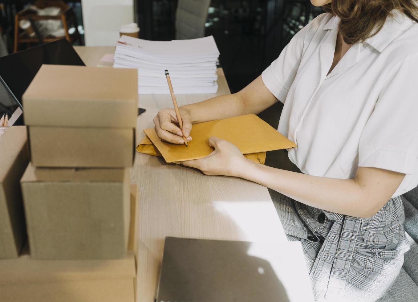 Portrait of Starting small businesses SME owners, two Asian woman check online orders Selling products working with boxs freelance work at home office, sme business online small medium enterprise photo