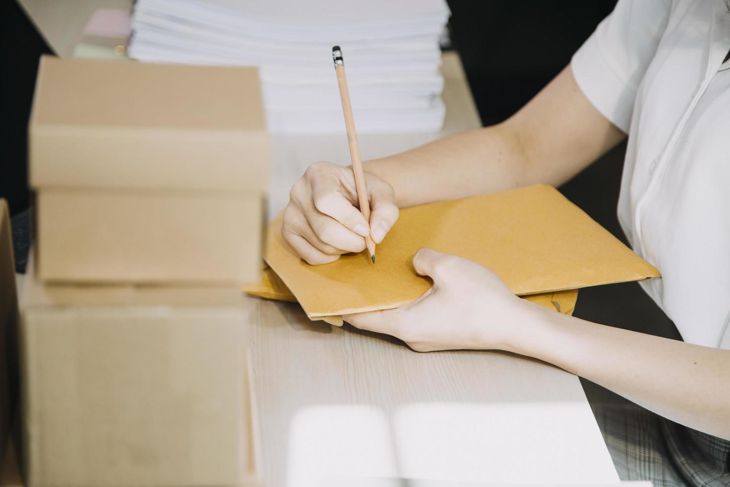 Portrait of Starting small businesses SME owners, two Asian woman check online orders Selling products working with boxs freelance work at home office, sme business online small medium enterprise photo