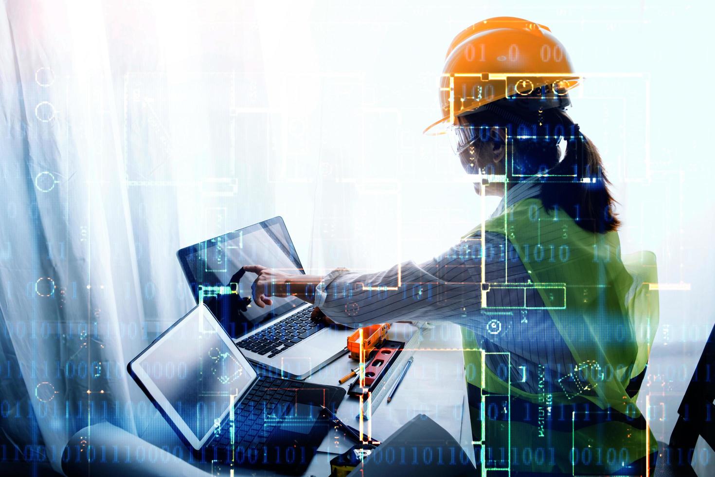business hand working and laptop with on on architectural project at construction site at office desk in office photo