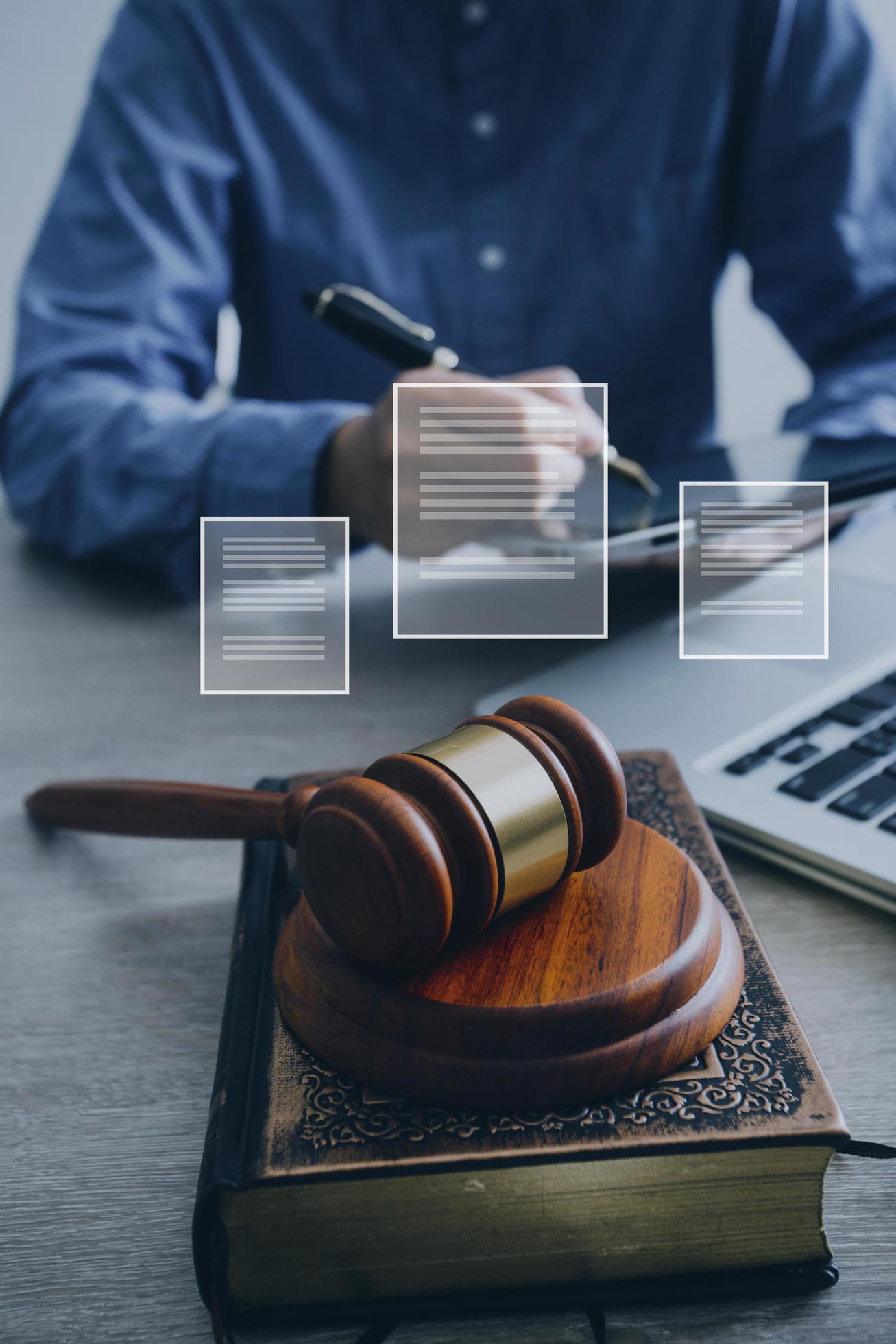 abogado masculino que trabaja con papeles de contrato y mazo de madera en tabel en la sala del