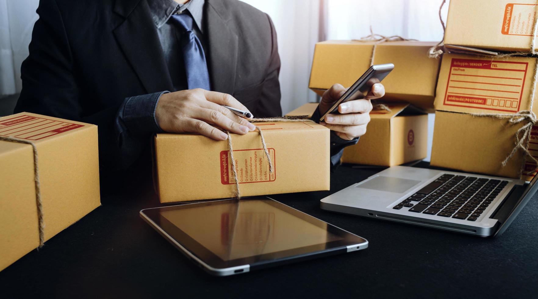 Business woman start up small business entrepreneur SME success .freelance woman working at home with Online Parcel delivery. SME and packaging deliveryconcept photo