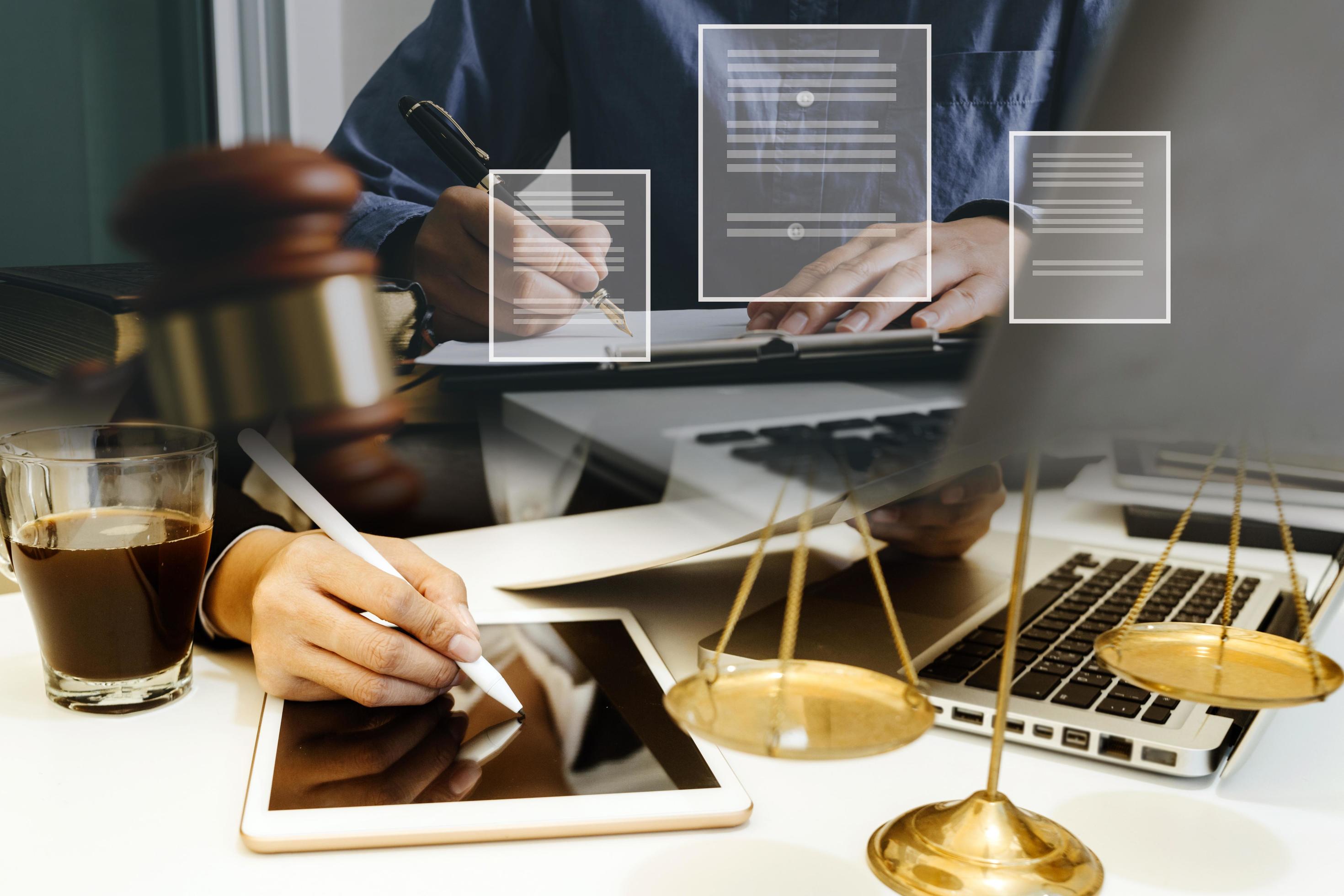 abogado masculino que trabaja con papeles de contrato y mazo de madera en tabel en la sala del