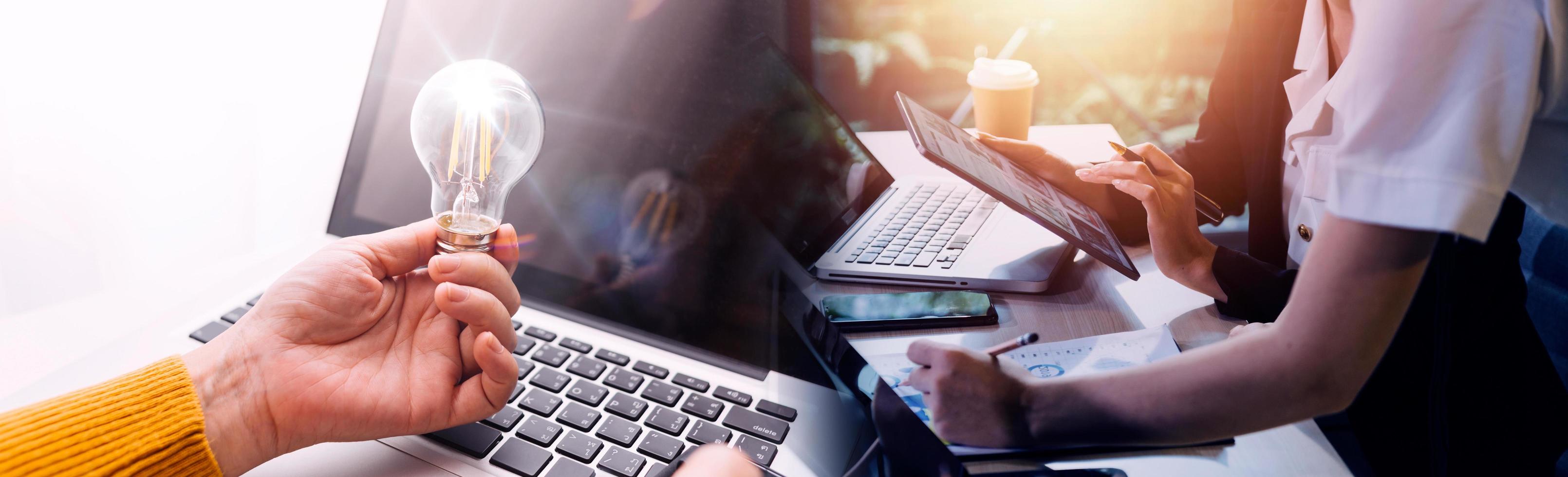 Business team finance or bookkeeper working with a calculator to calculate business data summary report, accountancy document and laptop computer at the office, business meeting concept photo