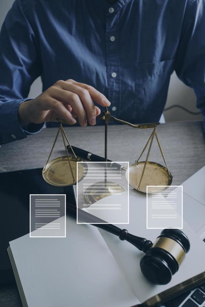 Male lawyer working with contract papers and wooden gavel on tabel in courtroom. justice and law ,attorney, court judge, concept. photo