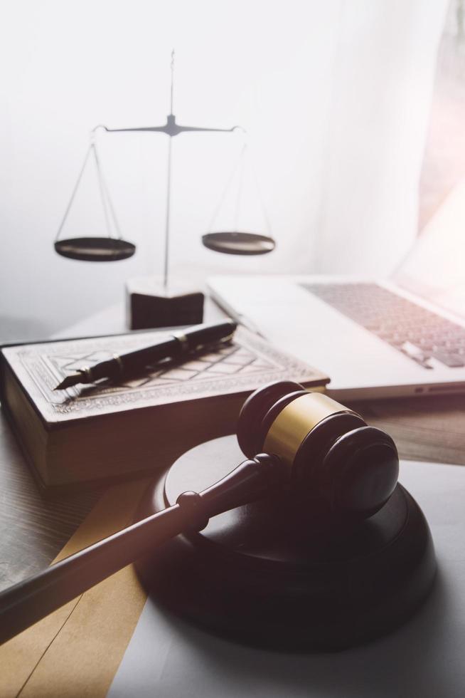 Business and lawyers discussing contract papers with brass scale on desk in office. Law, legal services, advice, justice and law concept picture with film grain effect photo