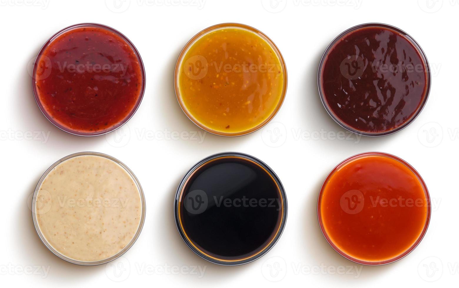 Different sauces isolated on white background, top view photo
