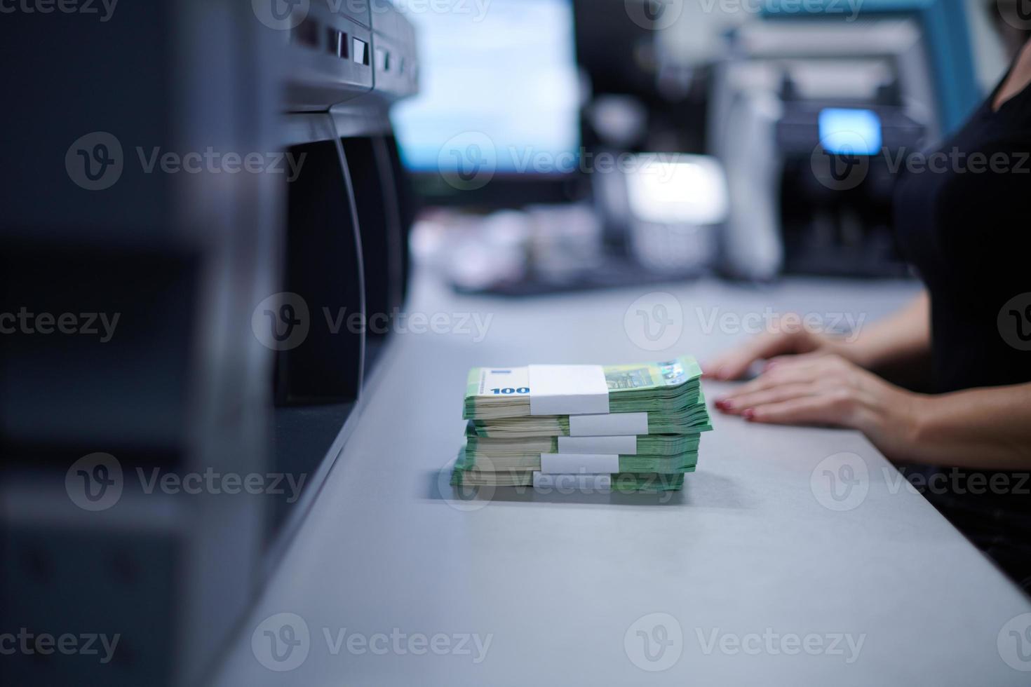 Bank employees sorting and counting paper banknotes photo