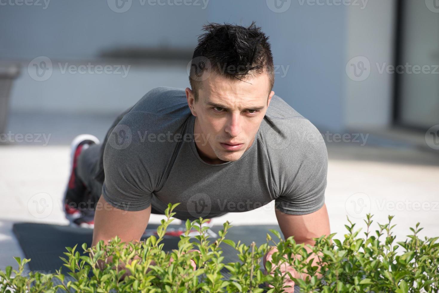 man doing morning yoga exercises photo