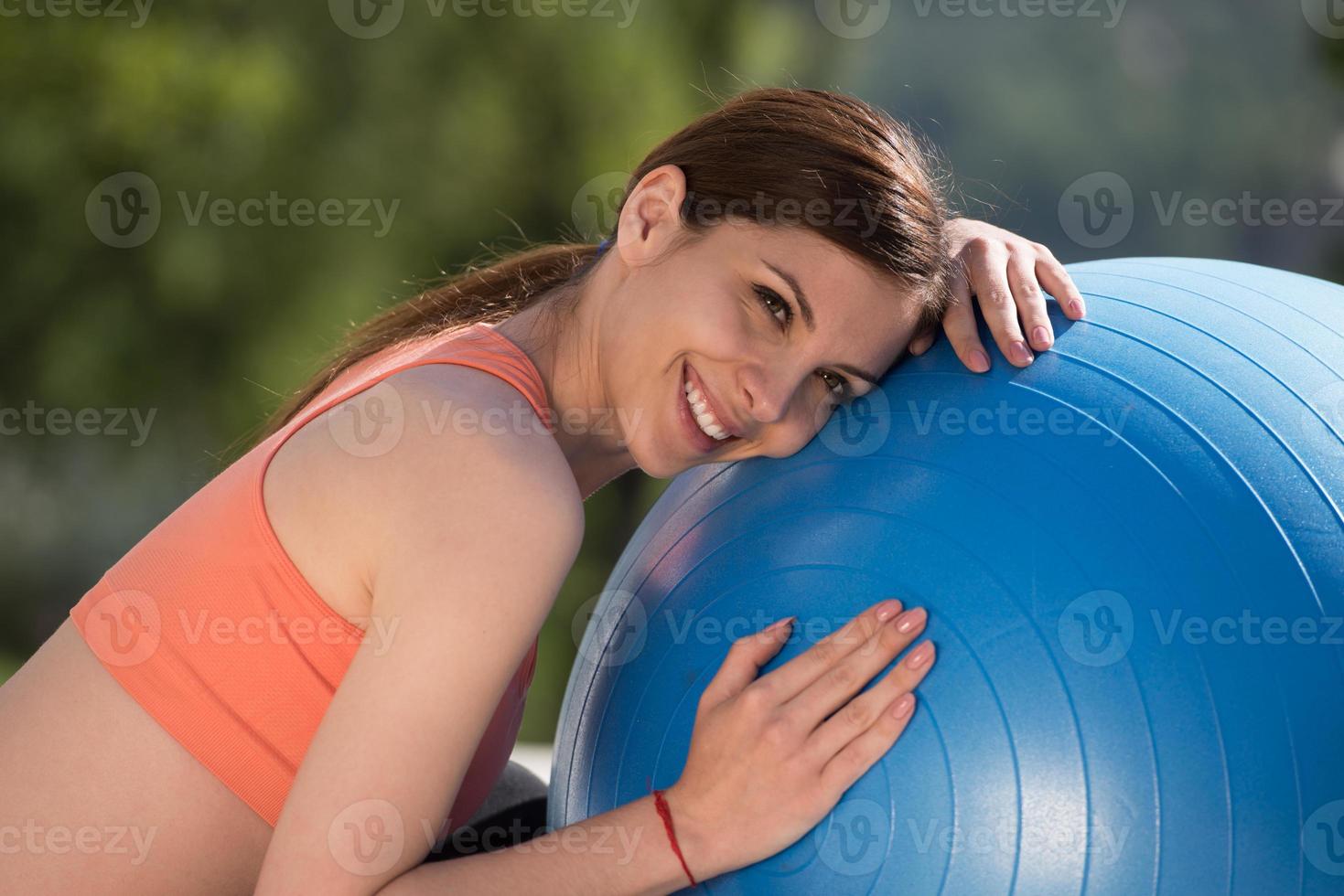 woman doing exercise with pilates ball photo