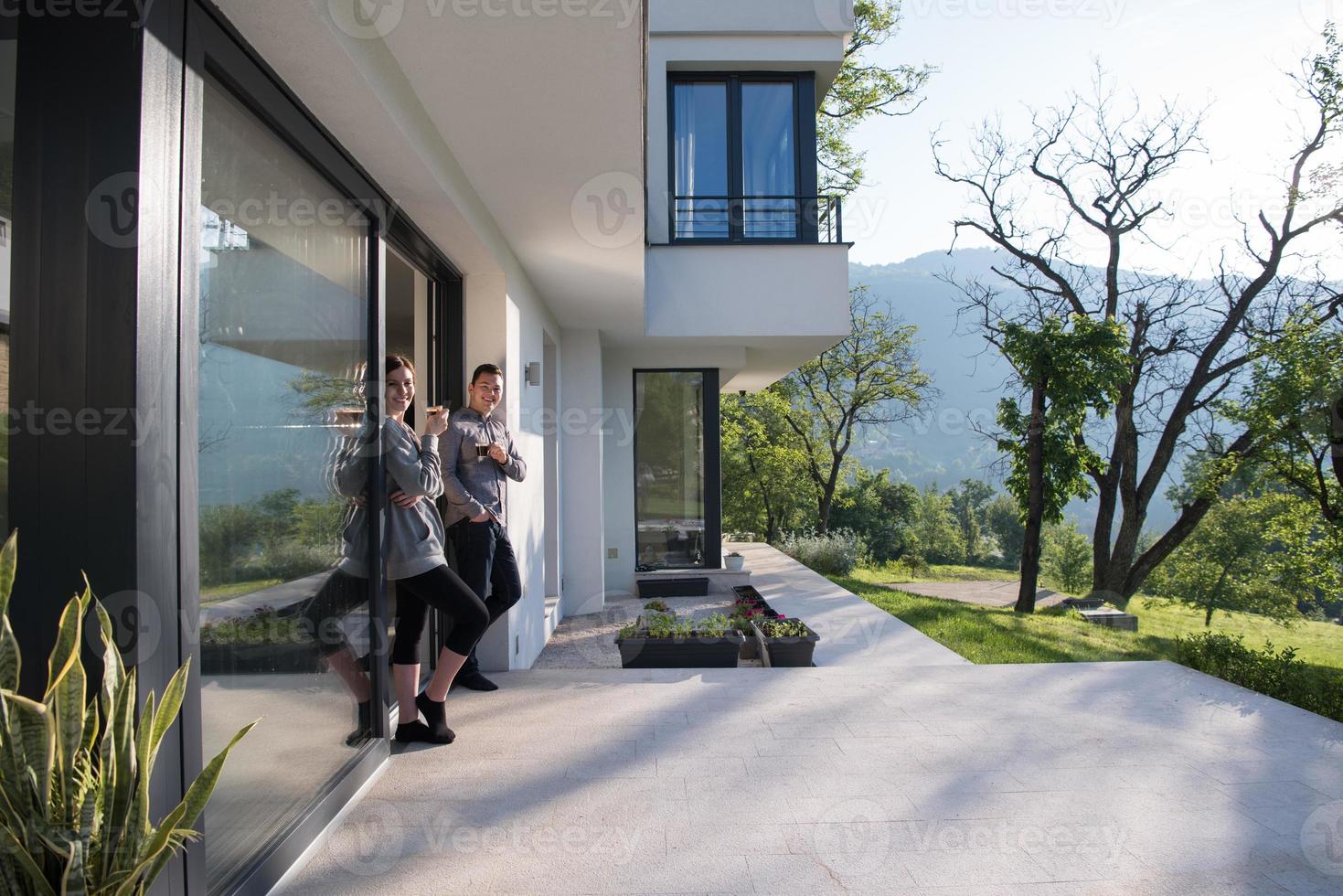 couple enjoying on the door of their luxury home villa photo