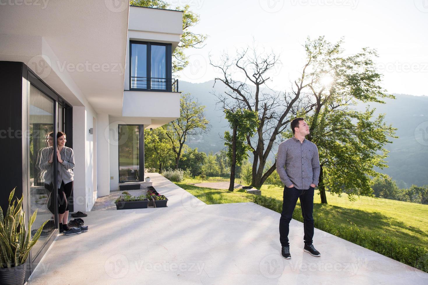 man in front of his luxury home villa photo