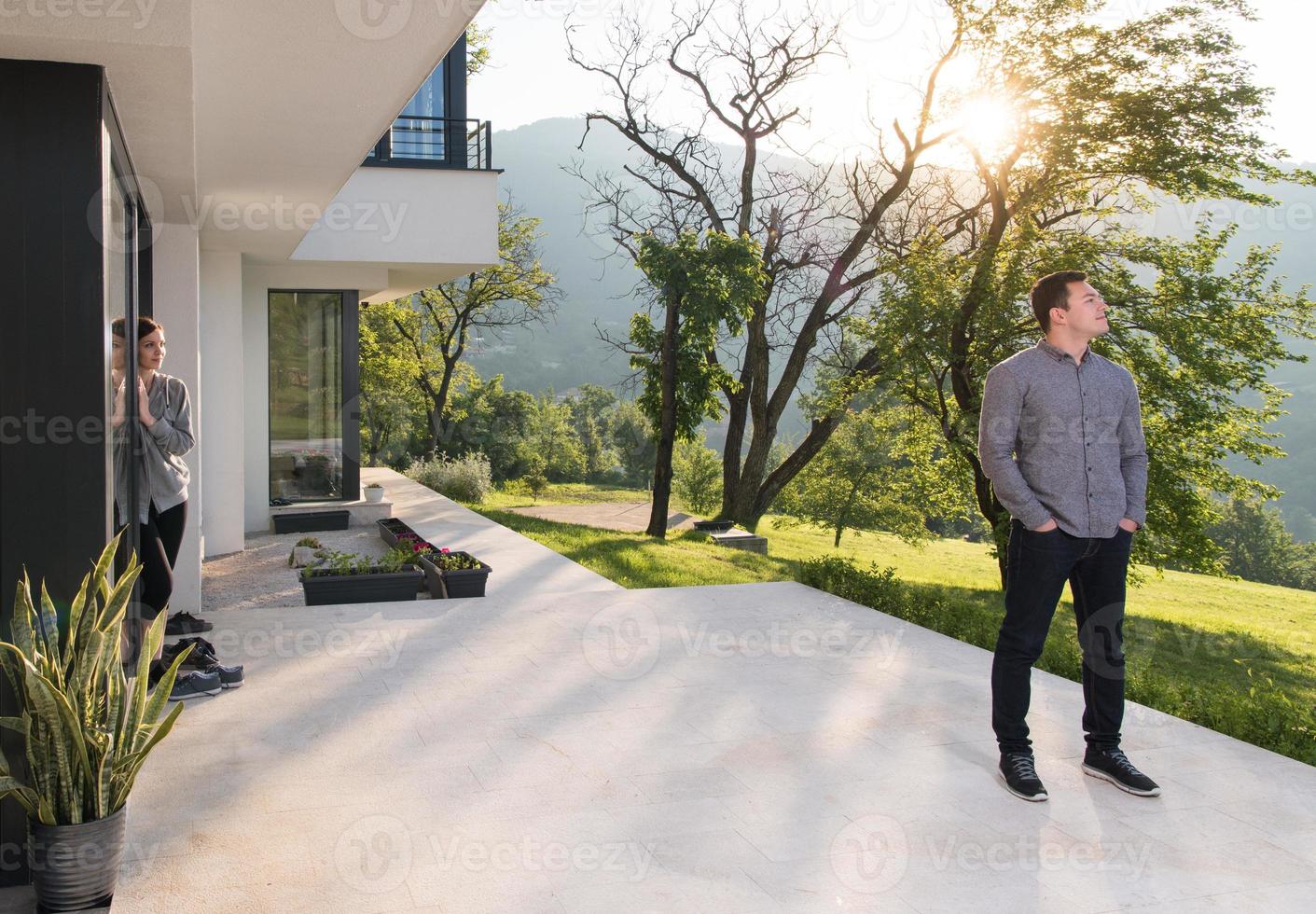 man in front of his luxury home villa photo