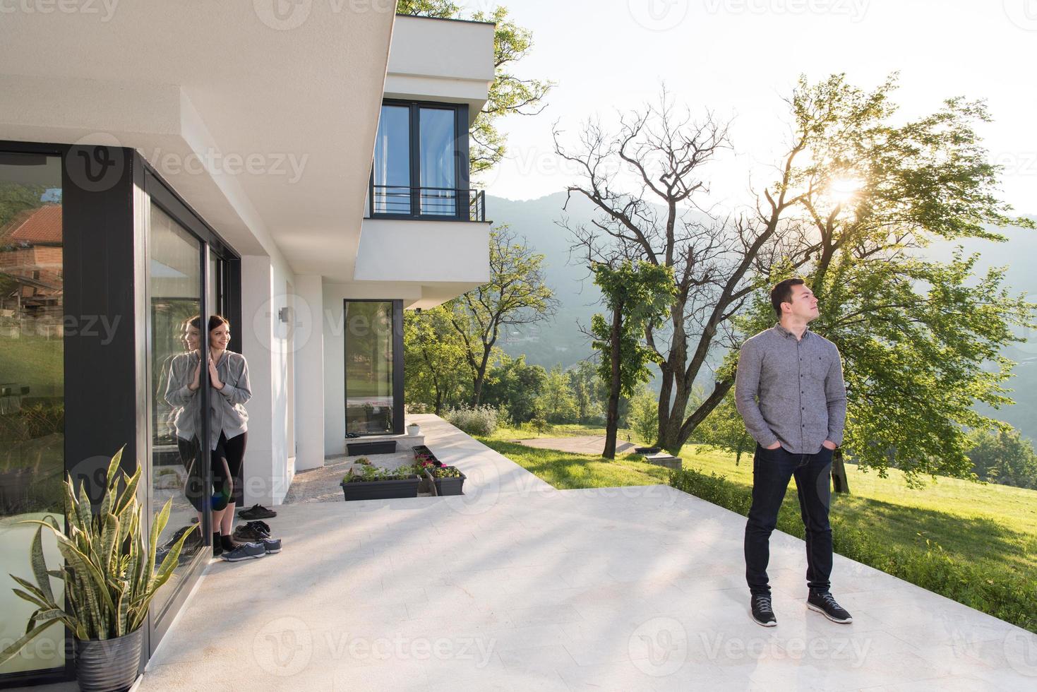 man in front of his luxury home villa photo