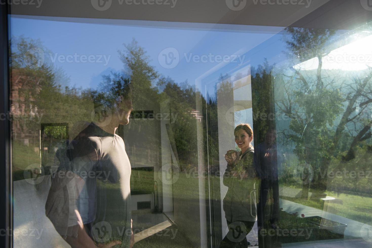 couple enjoying on the door of their luxury home villa photo