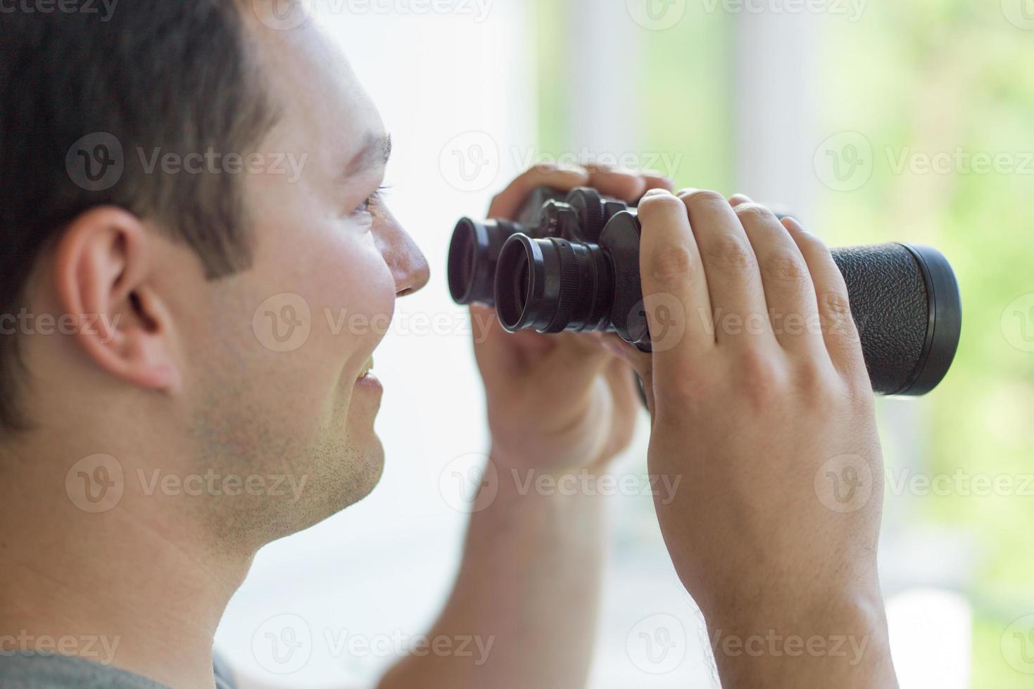 hombre mirando con binoculares foto