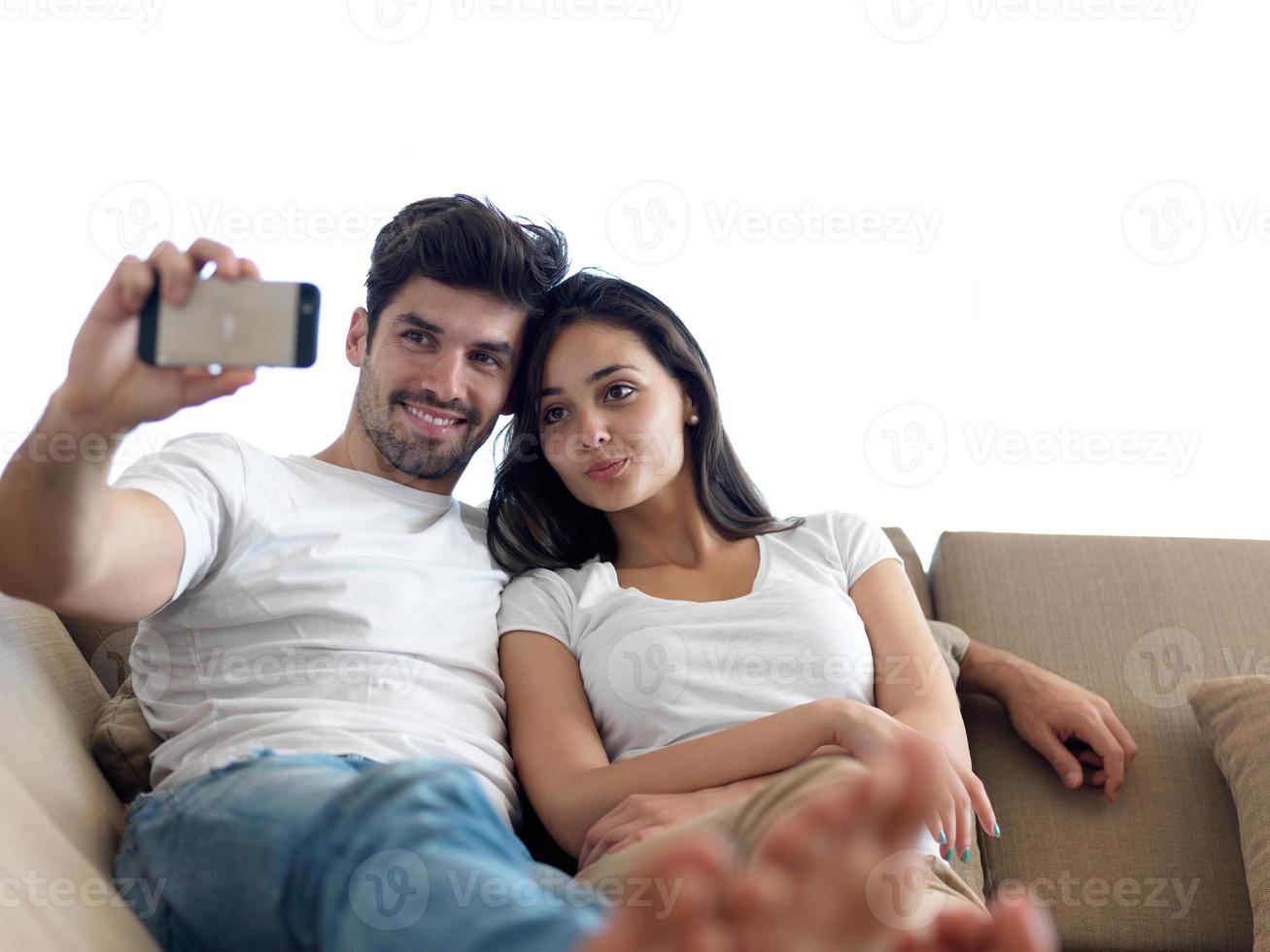 young couple making selfie together at home photo