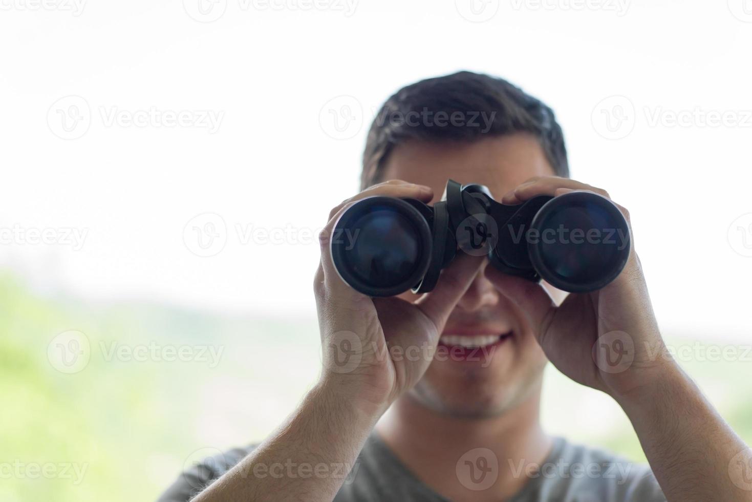 man looking with binoculars photo
