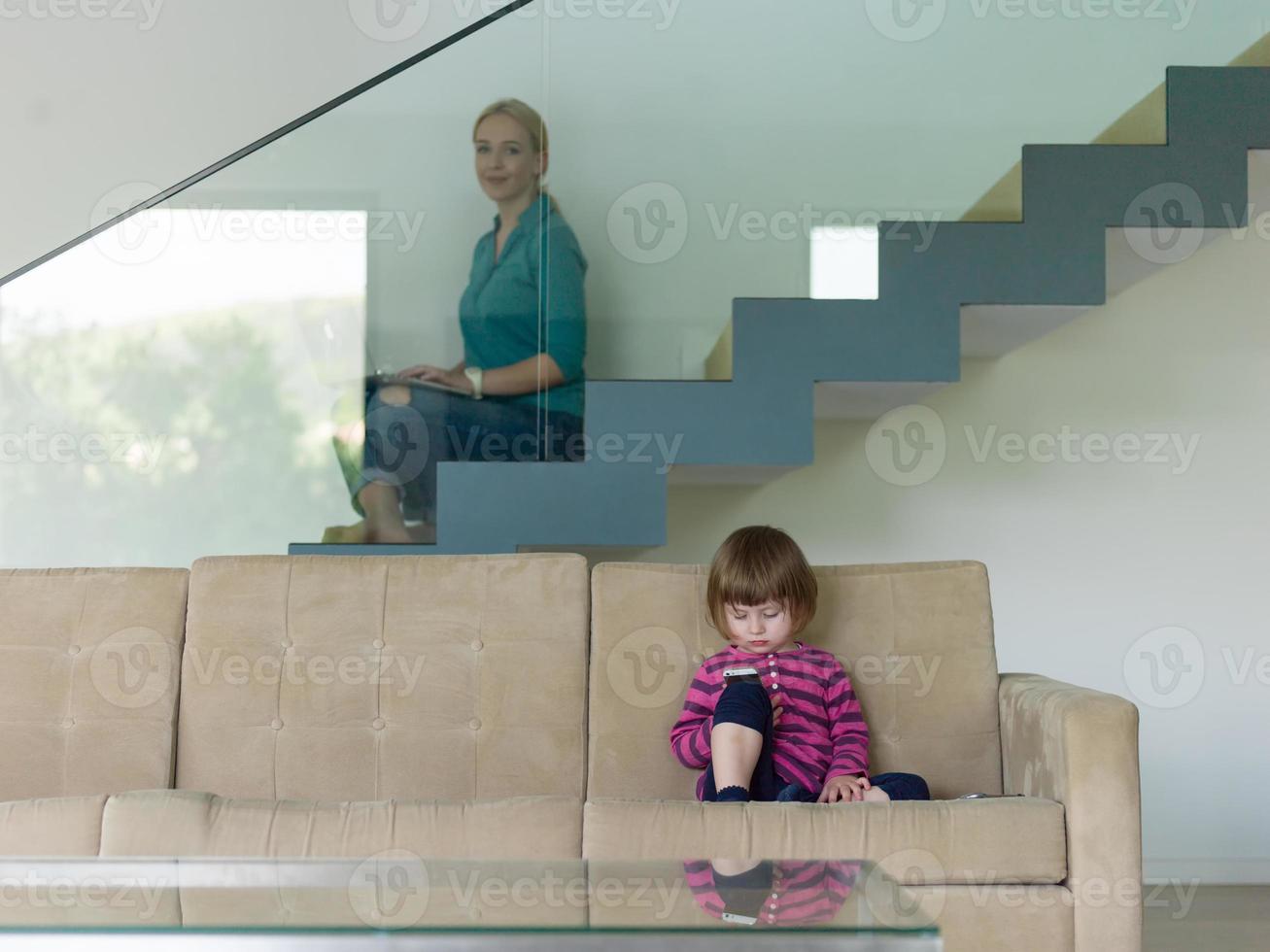 little girl playing games on smartphone photo